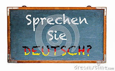 â€œSprechen Sie Deutsch?â€ in German language, Do you speak German? written on a wide blue old grungy vintage wooden chalkboard Stock Photo